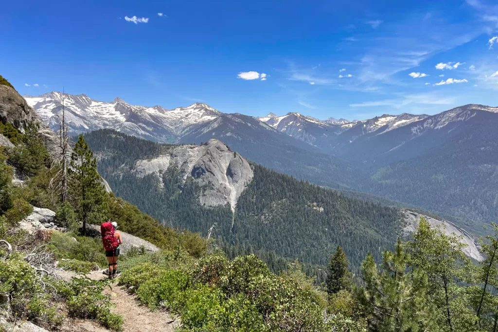 A solitary female backpacker gazes out over the Great Western Divide in California's Sequoia National Park.