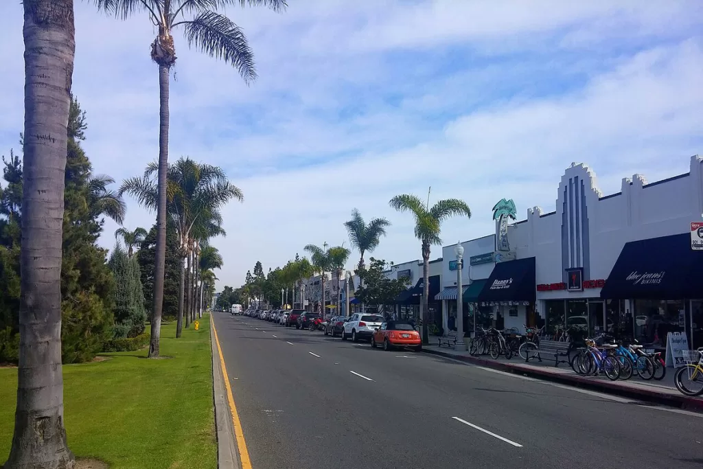 Cars and bicycles sit in front of local stores along Orange Avenue in Coronado, California.