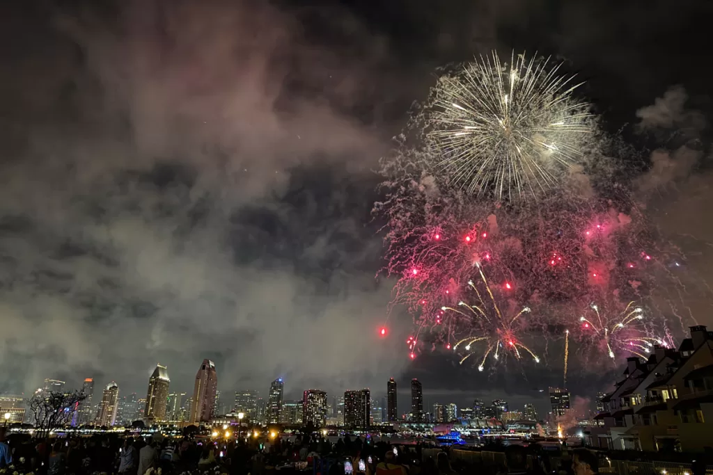 Fourth of July fireworks light up the night sky over the downtown San Diego skyline, as seen from the Ferry Landing in Coronado, California.