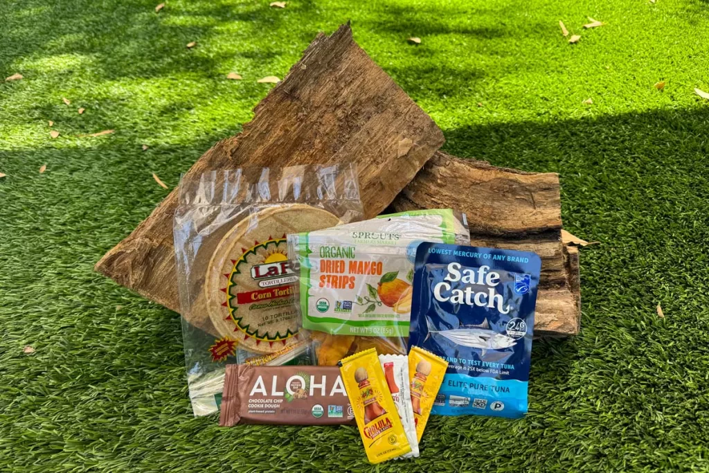 Sample backpacking food ideas for lunch are shown, including tuna wraps, dried fruit, and a protein bar.