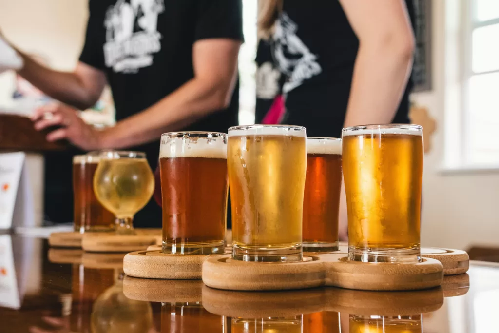A beer flight of tastings sits on a table.