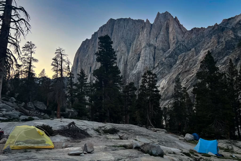 Dusk falls over two backpacking tents along the High Sierra Trail in California's Sierra Nevada mountains.