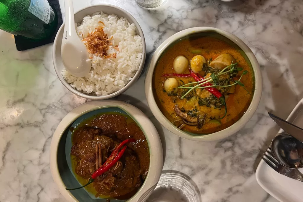 Bowls of elevated Indonesian cuisine sit on a table at Hujan Locale in Ubud, Bali, Indonesia