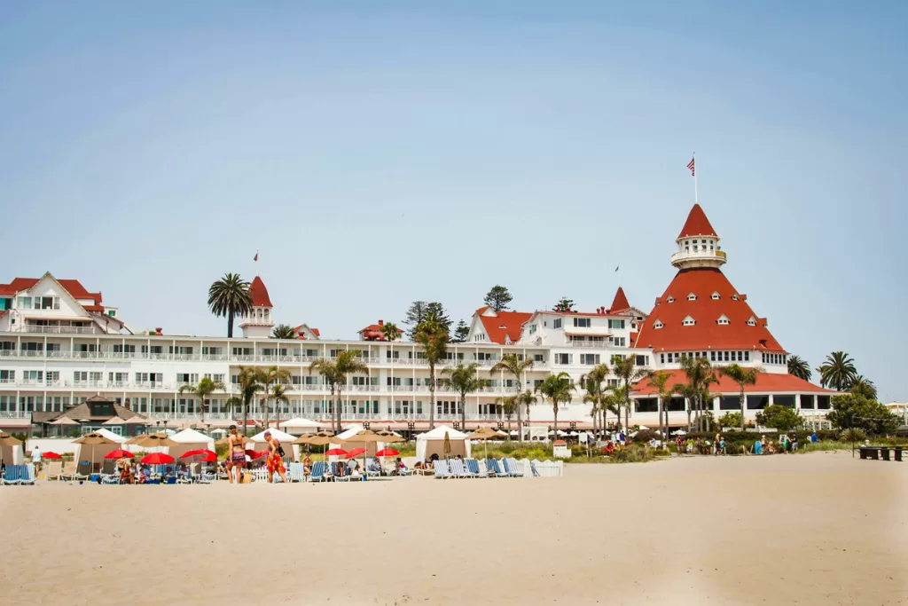 Umbrellas line the sand in front of the iconic Hotel Del Coronado in Coronado, California.