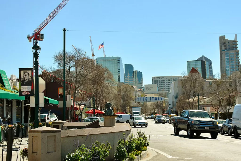Street scene in San Diego's Little Italy neighborhood, with downtown high rises in the background
