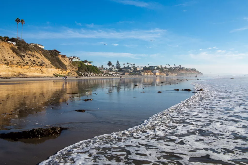 Waves lap the shoreline of Moonlight Beach in Encinitas, California.