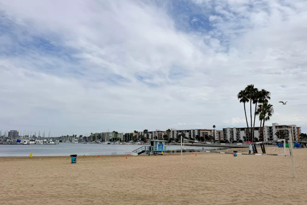 A lifeguard shack sits on the shore of Mothers Beach in Marina del Rey, California. Mothers Beach is one of the best beaches in LA for families.