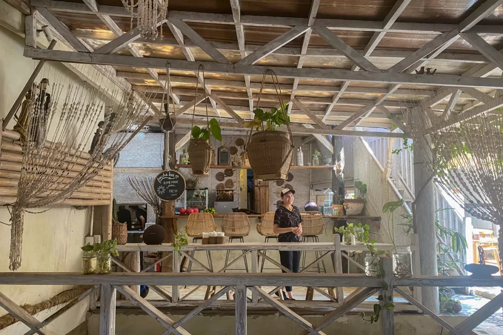 A woman stands at the counter of Pachamama, a wellness and health food restaurant on Gili Air off Lombok, Indonesia.
