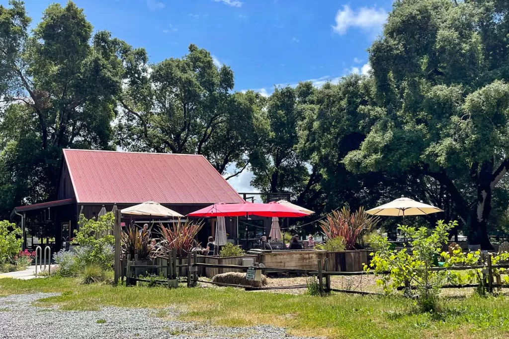 A red barn sits back among oak trees at Horse & Plow Winery in Sebastopol, California.