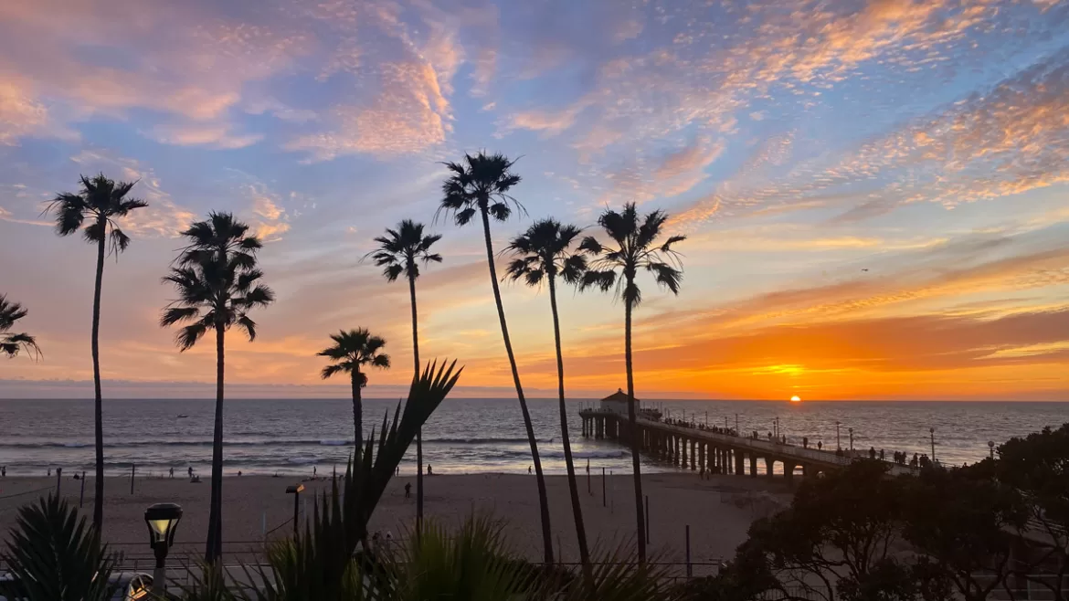Manhattan_Beach_Sunset_Feature A bright sunset lights up the sky above Manhattan Beach Pier in Los Angeles, California.