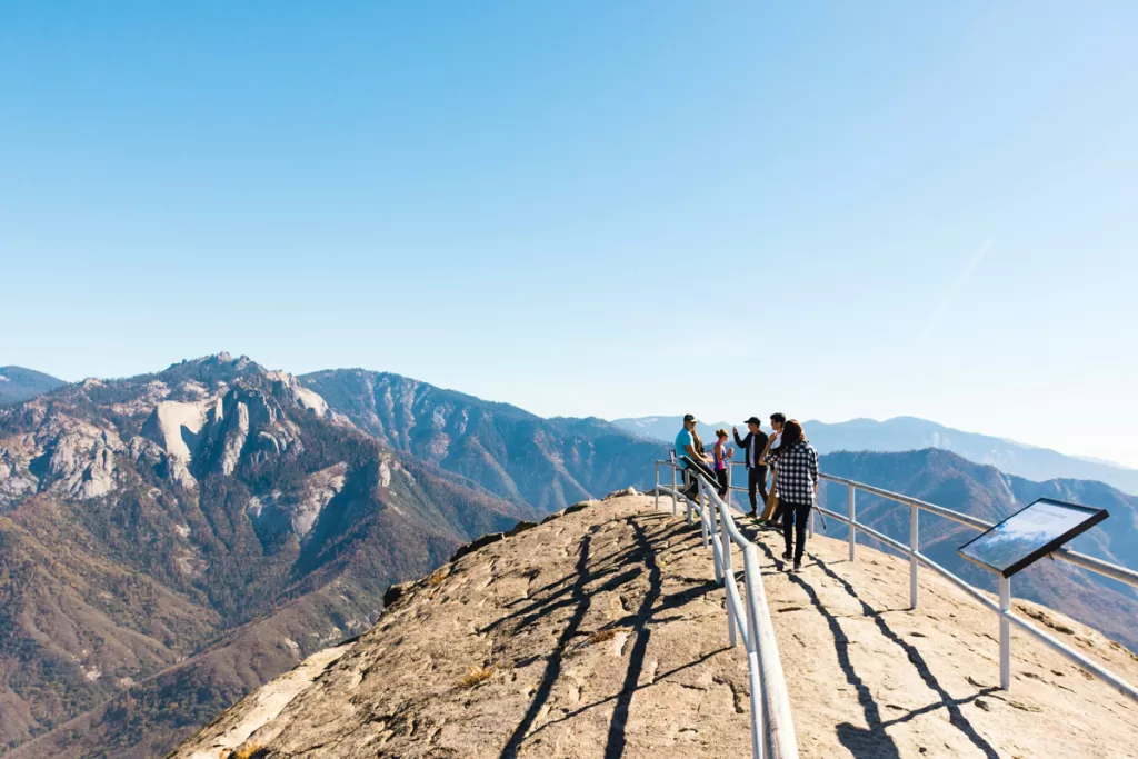 People stand along the guardrails of Moro Rock in California's Sequoia National Park.