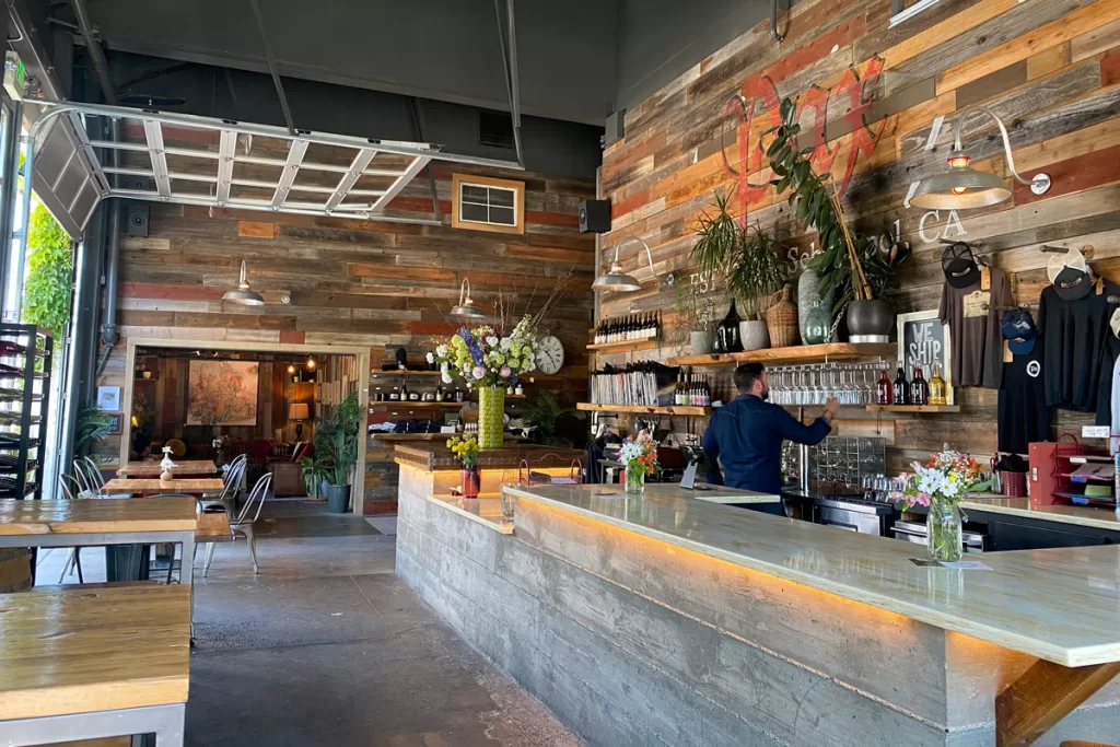 The industrial, wood-paneled interior of Pax Wines in Sebastopol, California. Pax is one of the original natural Sonoma wine spots in Sonoma County.