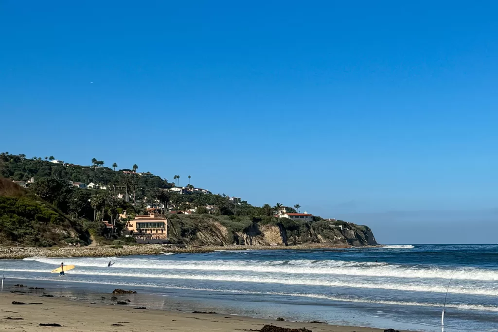 Two surfers wade out at RAT Beach near Palos Verdes, California.
